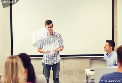 Image of group of smiling students and teacher in classroom