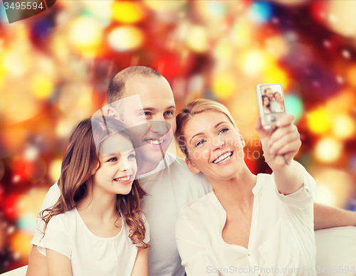 Image of happy family with camera at home