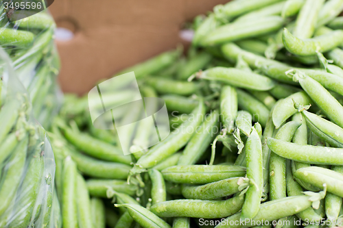 Image of close up of green peas in box at street market