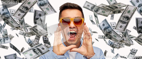 Image of face of shouting man with falling dollar money