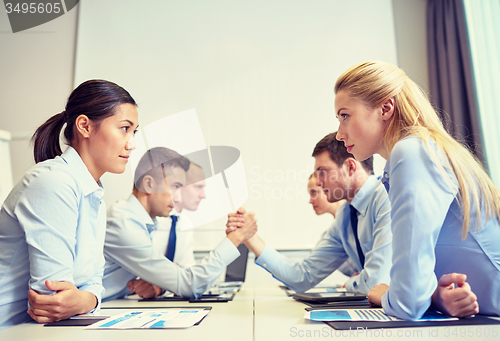 Image of smiling business people having conflict in office