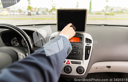Image of close up of young man with tablet pc driving car