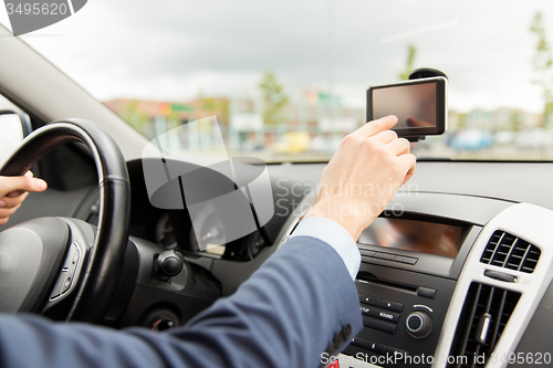 Image of close up of man with gps navigator driving car