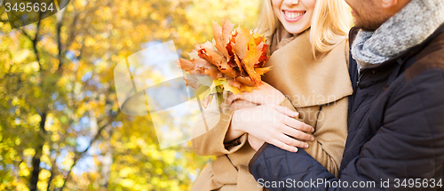 Image of close up of couple hugging over autumn background