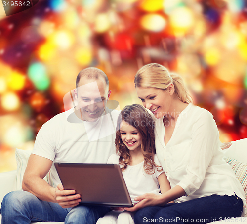 Image of smiling family with laptop