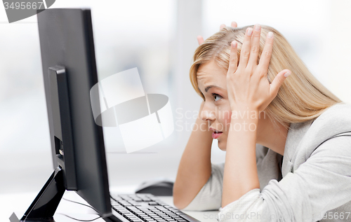 Image of stressed woman with computer