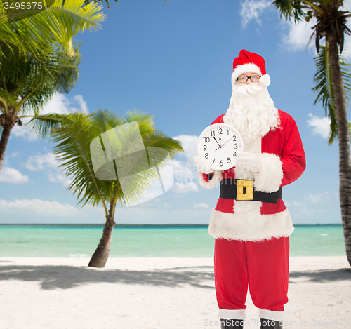 Image of man in costume of santa claus with clock