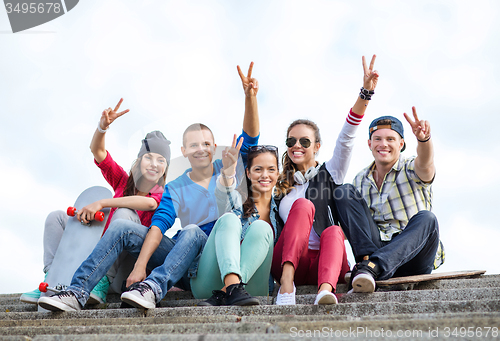 Image of group of teenagers showing finger five