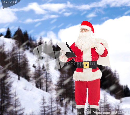 Image of man in costume of santa claus with notepad and bag