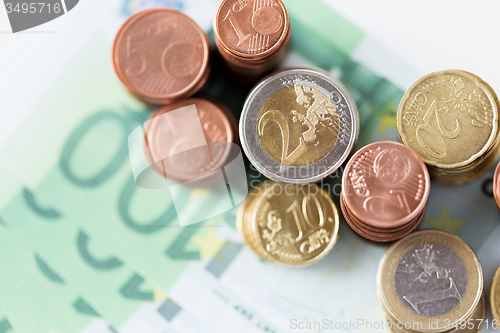 Image of close up of euro paper money and coins on table