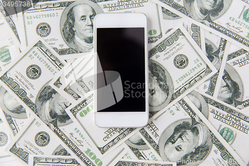 Image of close up of smartphone and dollar money