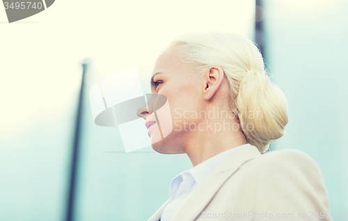 Image of young businesswoman over office building