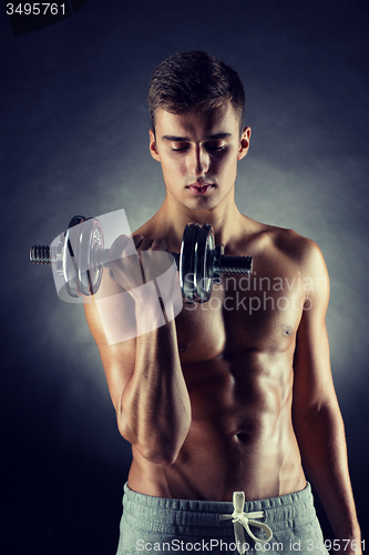 Image of young man with dumbbell