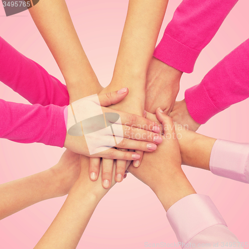 Image of close up of women with hands on top