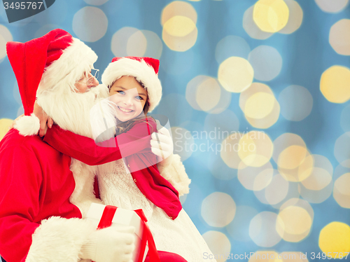 Image of smiling little girl with santa claus