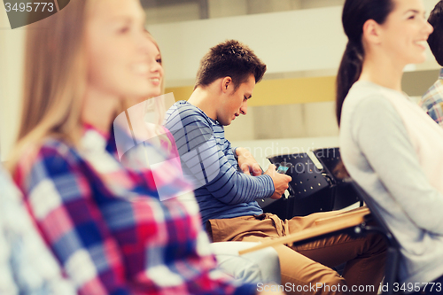 Image of group of smiling students in lecture hall