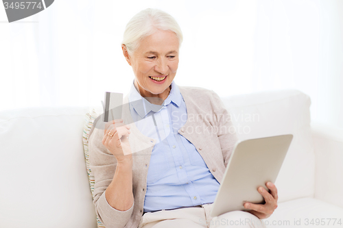Image of senior woman with tablet pc and credit card