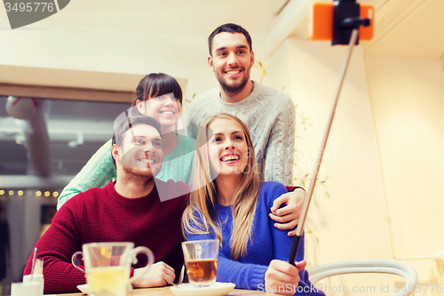 Image of group of friends taking selfie with smartphone
