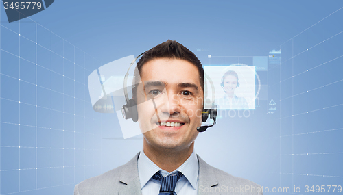 Image of happy businessman in headset with virtual screens