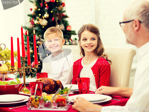 Image of smiling family having holiday dinner at home