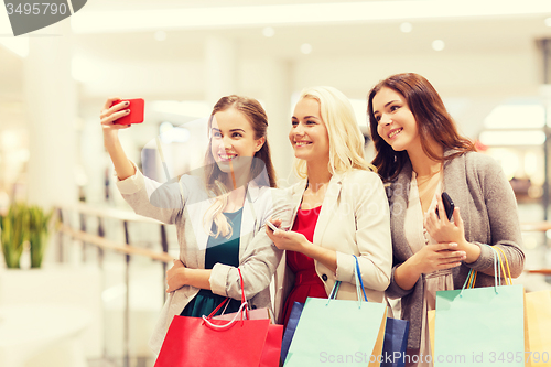 Image of women with smartphones shopping and taking selfie