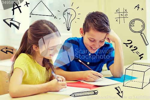 Image of group of school kids writing test in classroom