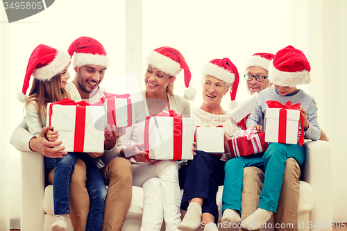 Image of happy family sitting on couch at home