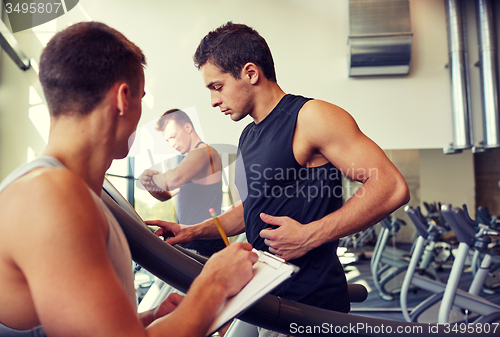 Image of men exercising on treadmill in gym