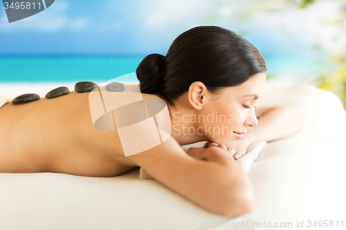 Image of woman in spa with hot stones