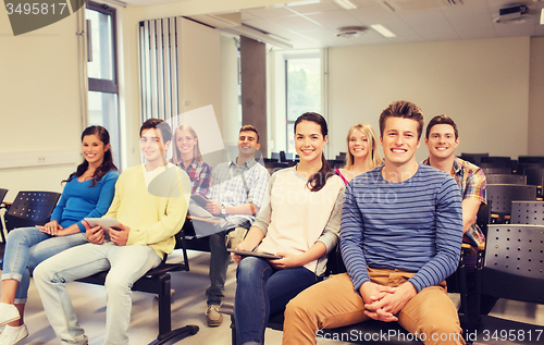 Image of group of smiling students with tablet pc