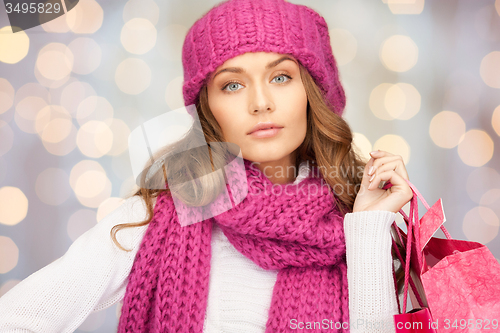 Image of young woman in winter clothes with shopping bags