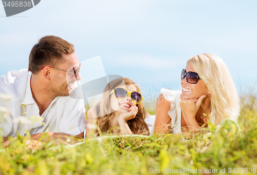 Image of happy family with blue sky and green grass