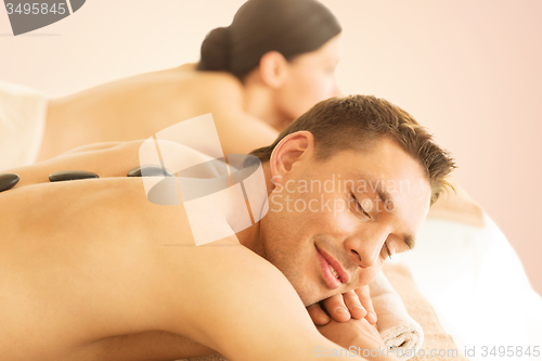 Image of couple in spa with hot stones