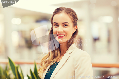 Image of happy young woman in mall or business center