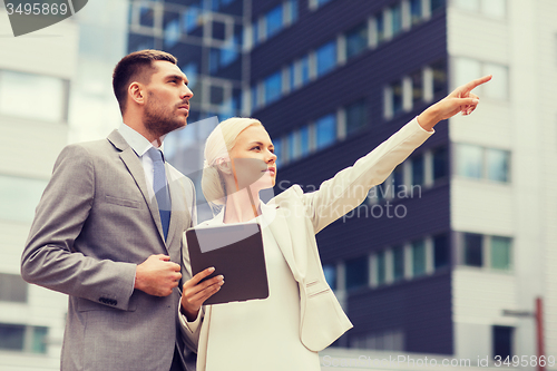 Image of serious businessmen with tablet pc outdoors