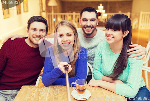 Image of group of friends taking picture with selfie stick