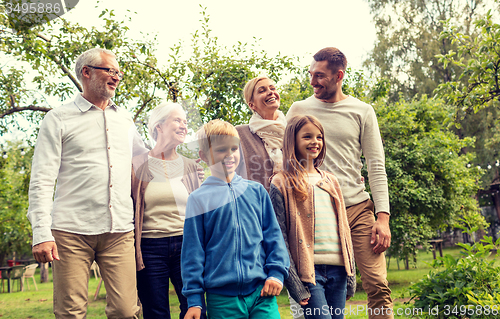 Image of happy family in front of house outdoors