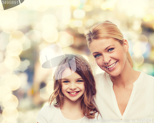 Image of smiling mother and little girl