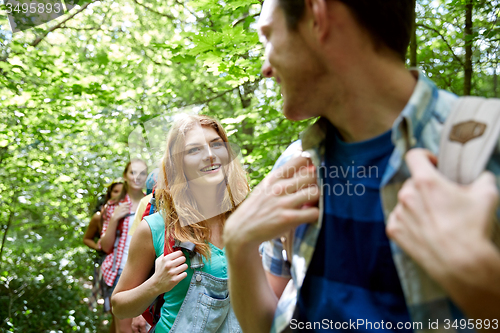 Image of group of smiling friends with backpacks hiking