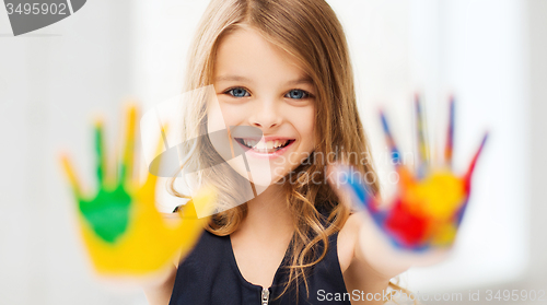 Image of smiling girl showing painted hands