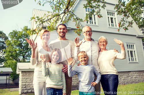 Image of happy family in front of house outdoors