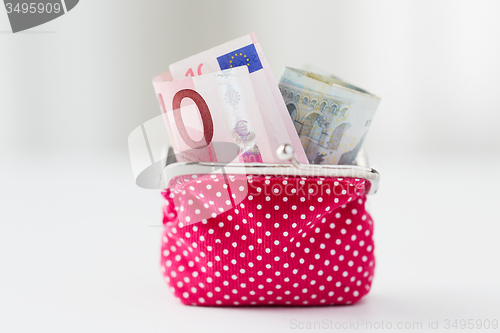 Image of close up of euro paper money in pink wallet