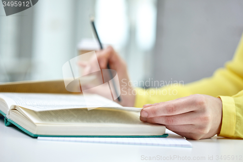 Image of close up of female hands to book or textbook