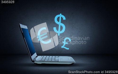 Image of laptop computer with lighting currency symbols