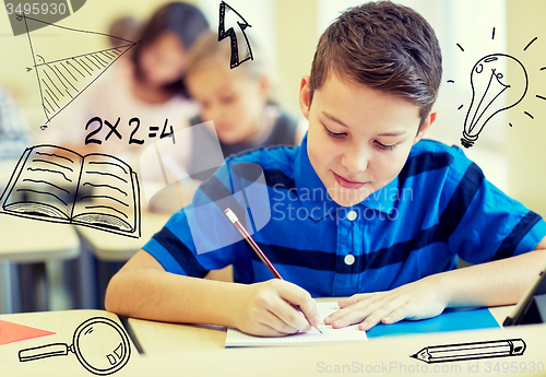 Image of group of school kids writing test in classroom