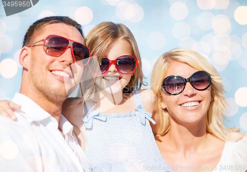 Image of happy family over blue lights background