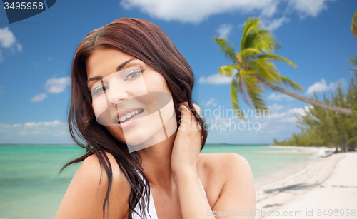 Image of happy young woman on beach