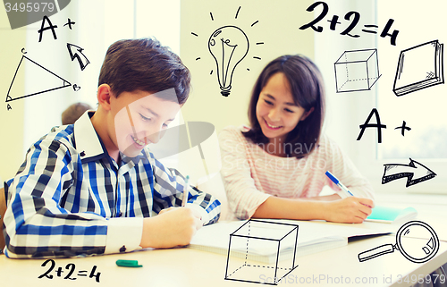 Image of group of school kids writing test in classroom