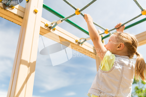 Image of close up of girl climbing on children playground