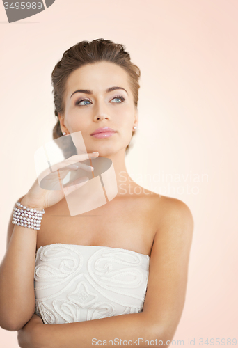 Image of woman with pearl earrings and bracelet